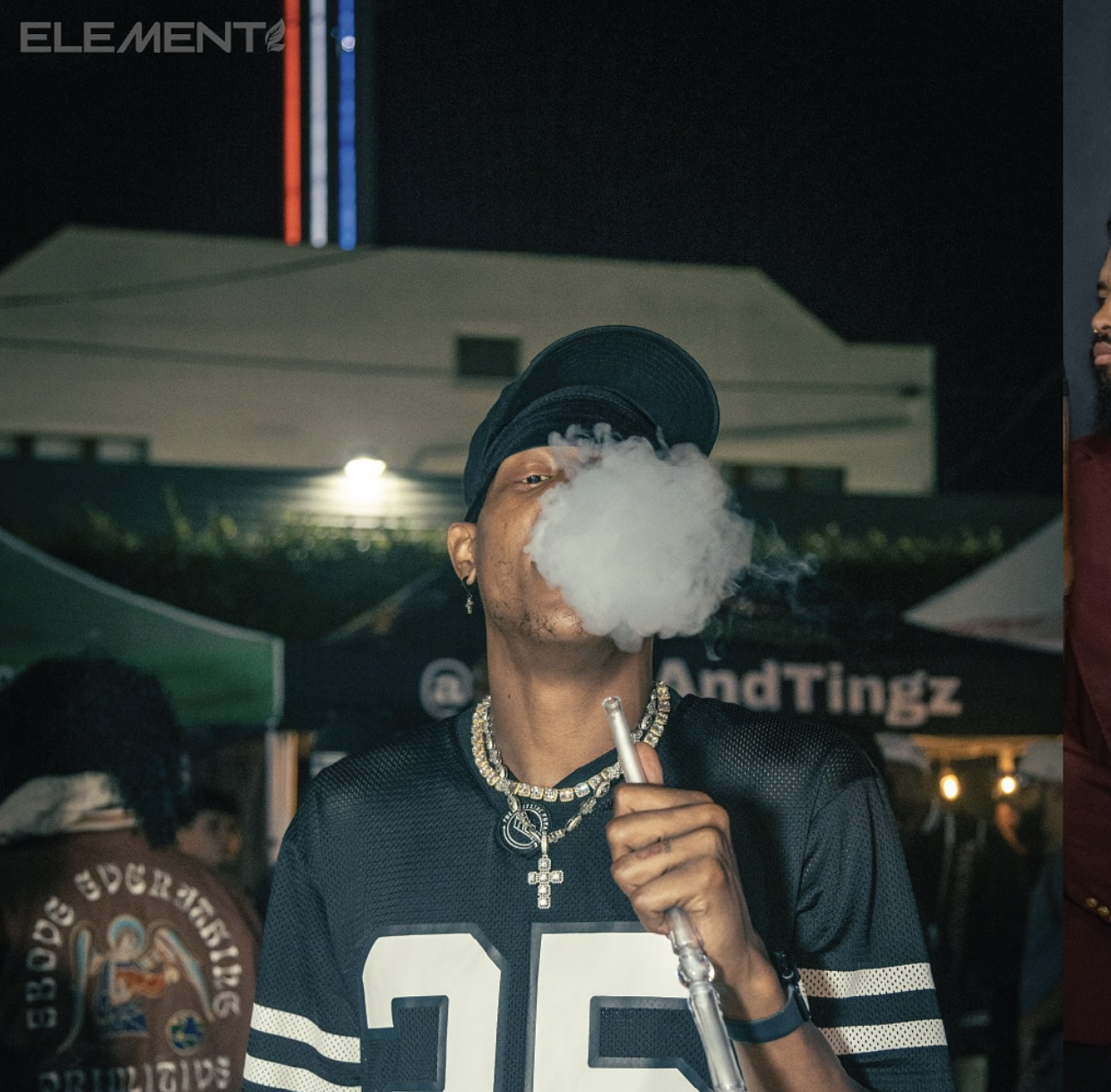 Guest enjoying hookah at an Element event with a smoke cloud in front of his face.